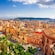 Cityscape of Cagliari, Italy, featuring terracotta roof building and a sprawling hillside